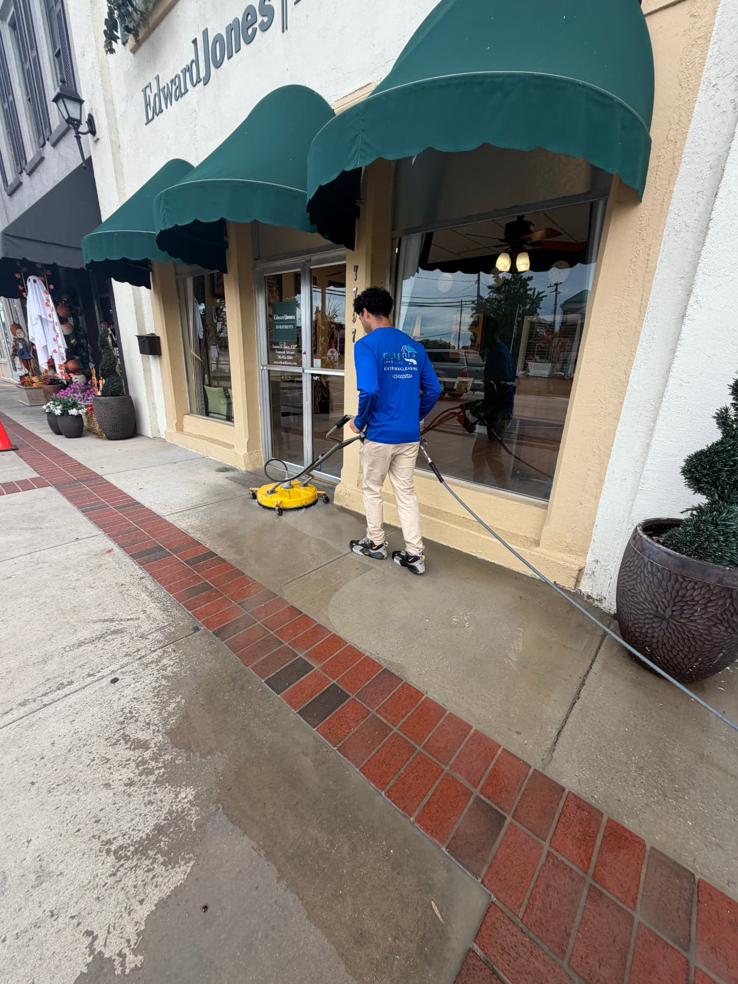 Curb Appeal cleaning a commercial storefront sidewalk